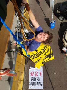 Rollstuhlkletterin lächelt in der Sonne, von oben aufgenommen